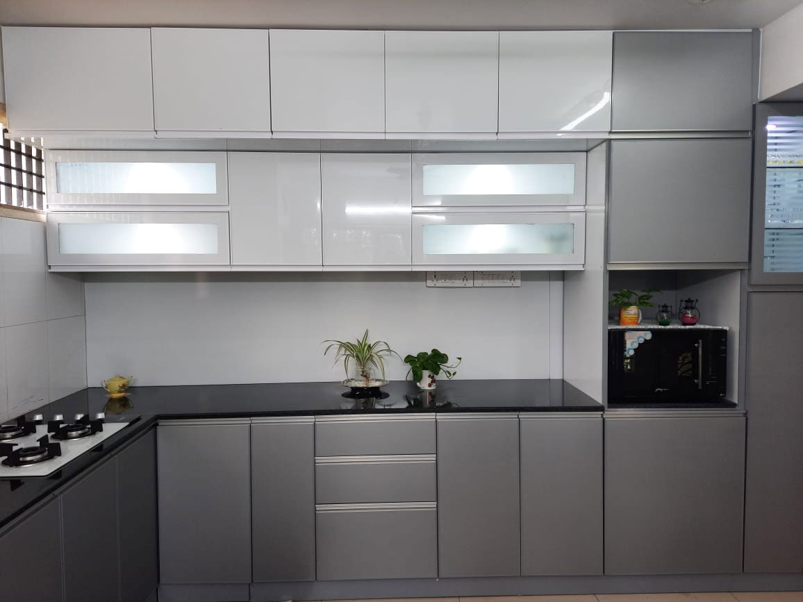 White and grey aluminium cupboards with glass upper shutters